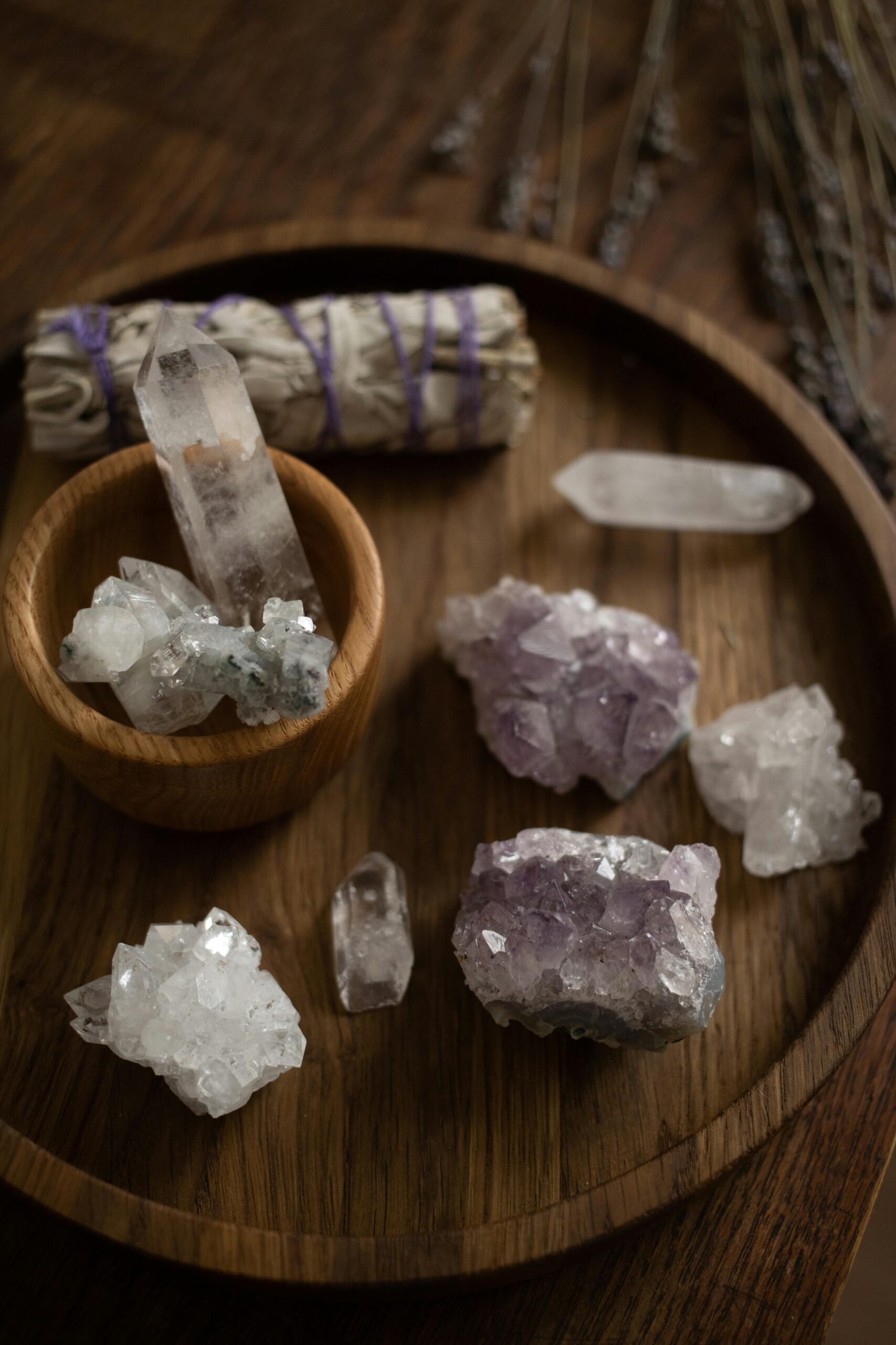 A collection of healing crystals on a wooden tray for alternative therapy and crystal healing.